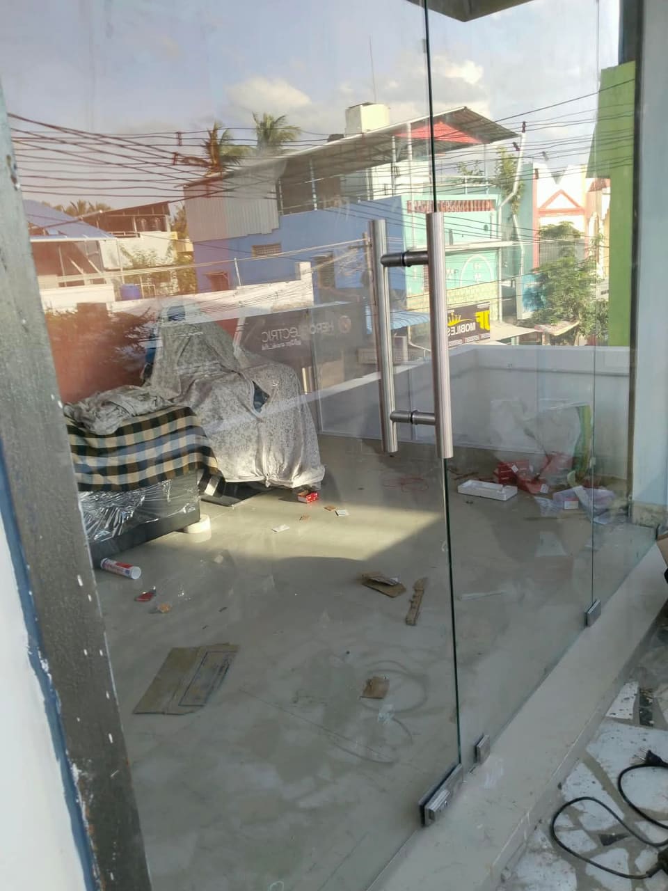 Long stainless-steel pull handle on a frameless glass door