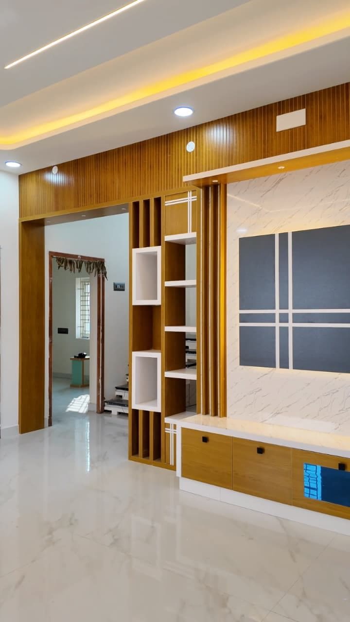 Living room with wooden slat wall, open shelving and a cove-lit false ceiling