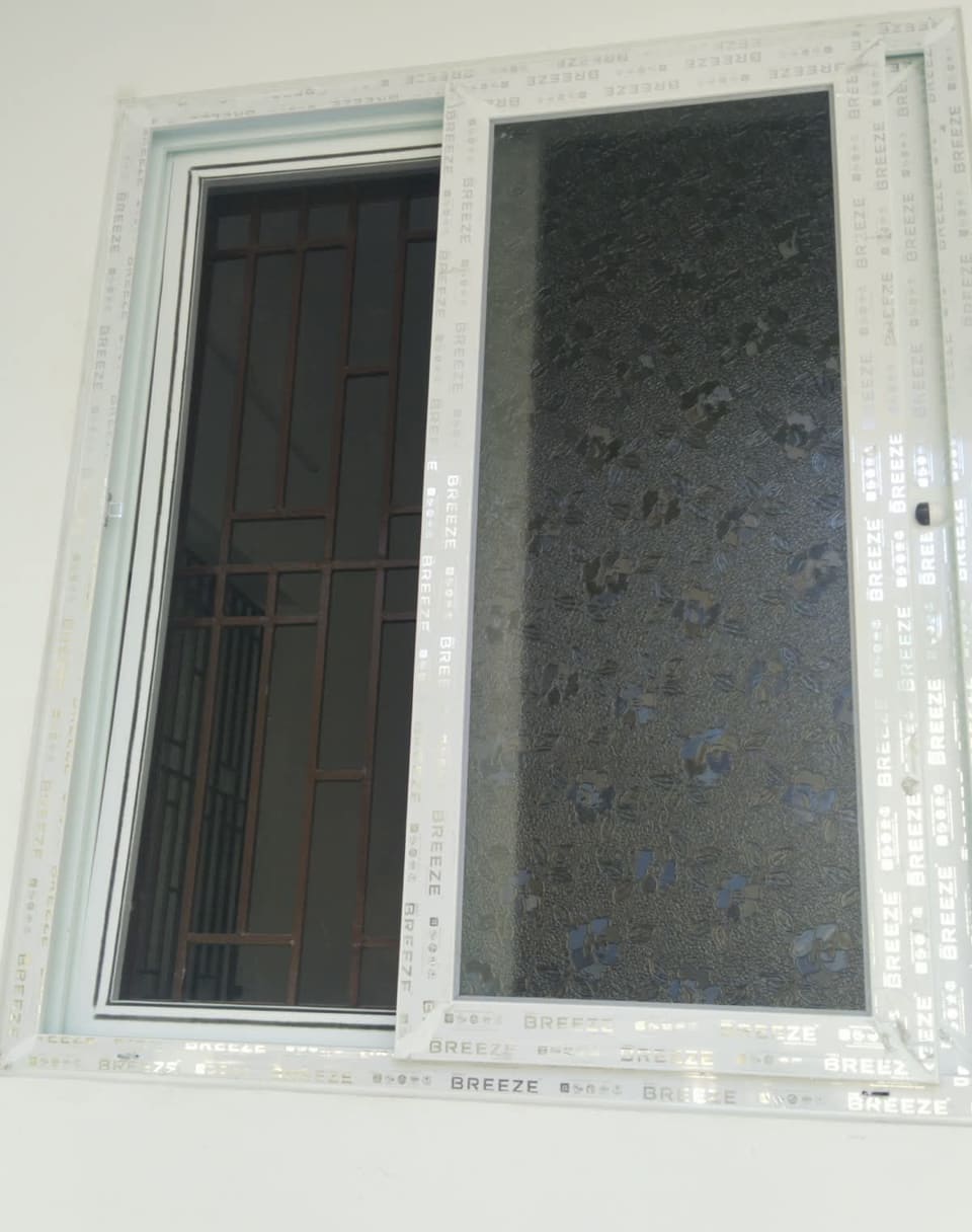 White UPVC sliding window installed in a bedroom wall