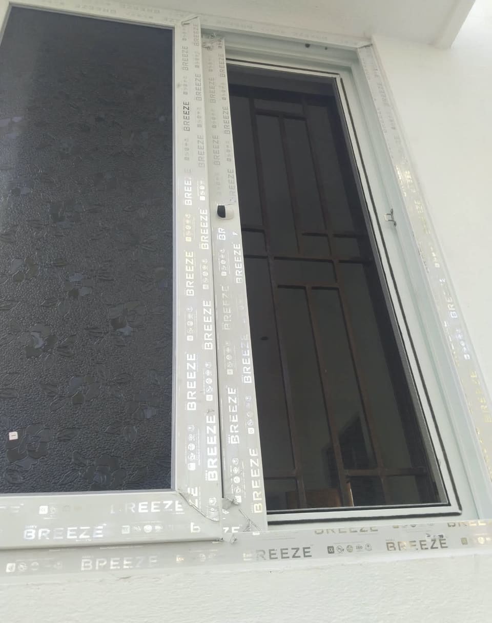 UPVC sliding window being fitted on site, protective film still on