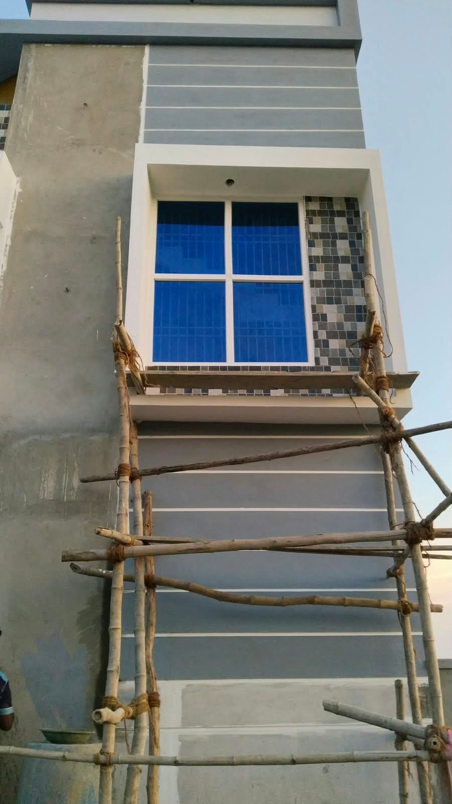 Window fitted into a building elevation during construction